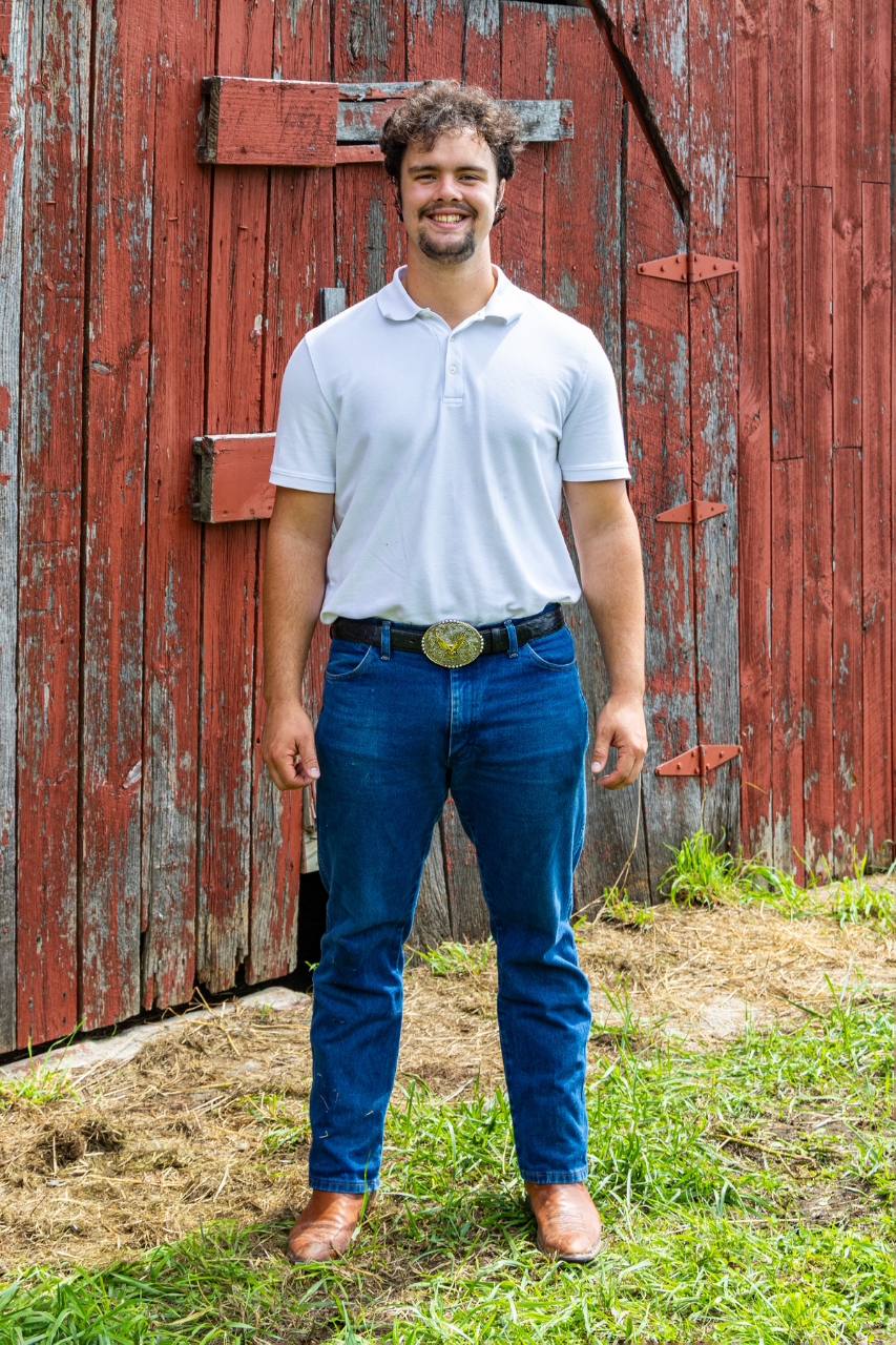 Peter Fast standing in front of a red barn
