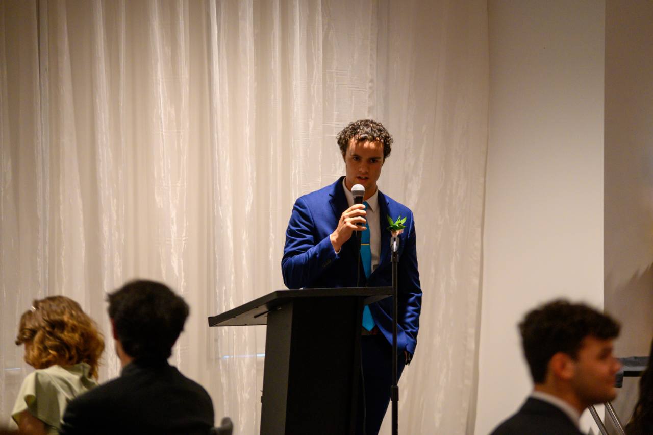 Peter Fast delivering a speech to his high school senior class in 2023