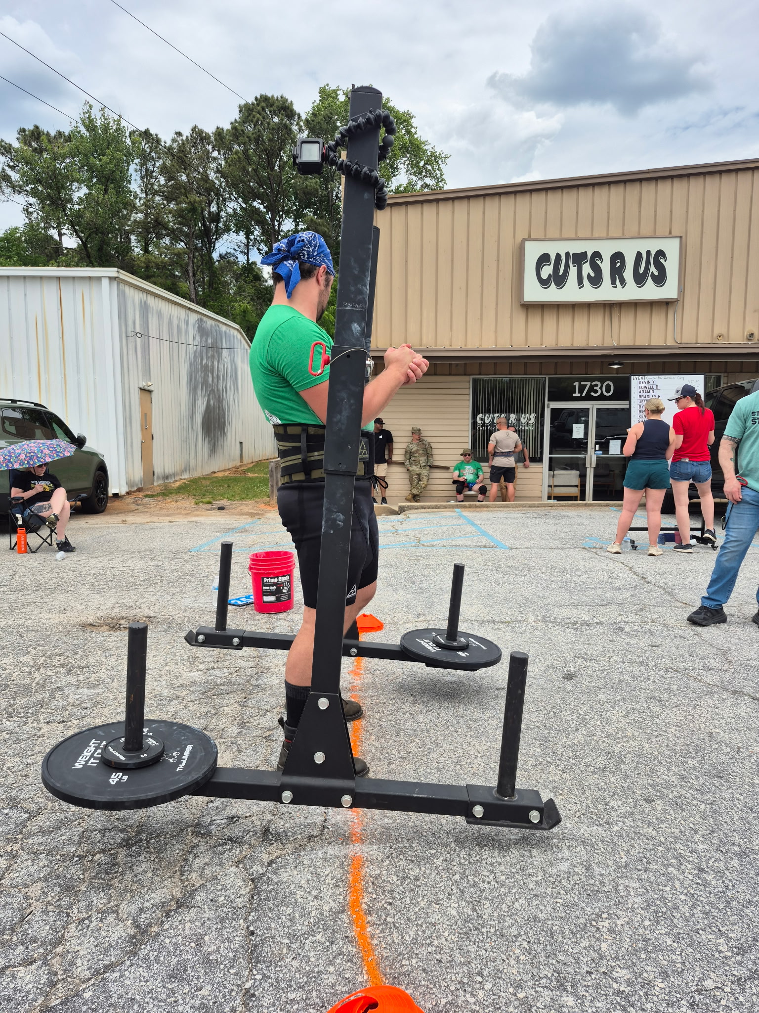 Strength athlete carrying a loaded yoke during an outdoor competition